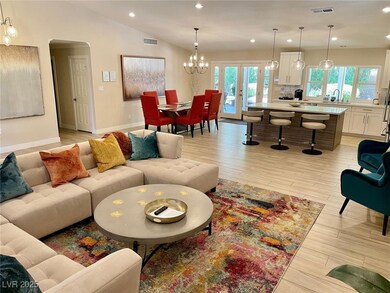 Living area with recessed lighting, light wood-sty