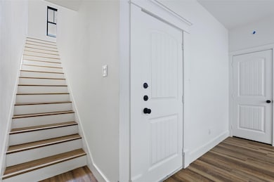 Entryway with dark hardwood / wood-style floors