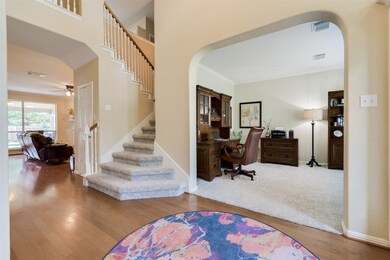 A narrowed view of the dramatic 2 story entryway and the Study or Formal Living Area