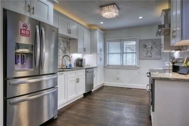 Kitchen featuring tasteful backsplash, dark wood f