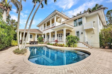 Back of house with ceiling fan, a balcony, and a p