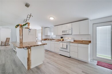 Kitchen featuring butcher block counters, light ha