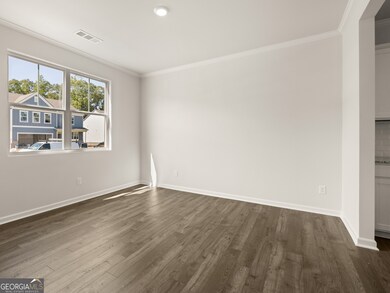 halton open dining room with large dobule window and hardwood-like flooring