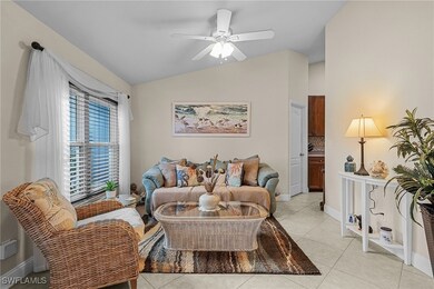 Living room with ceiling fan, baseboards, lofted c