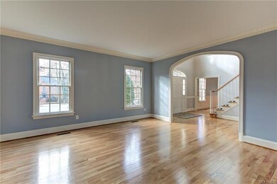 This spacious living room with refinished floors i