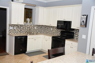 Kitchen has been updated with granite counter, til