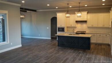 Open kitchen to living, dining to right, hallway n