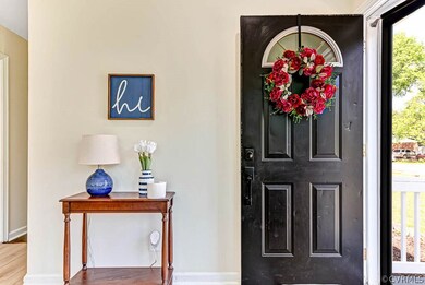 Entrance foyer with hardwood / wood-style floors