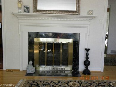 Wood burning fireplace with beautiful wood mantle.