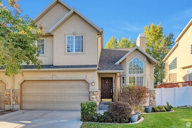 Traditional-style house with a shingled roof, stone siding, stucco siding, and driveway