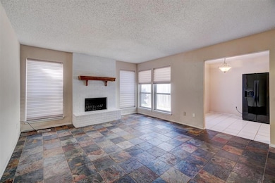 Unfurnished living room with a textured ceiling an