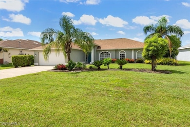 View of front of property featuring driveway, a ga