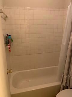 Full bathroom with toilet and shower / bath combo