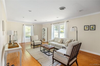 Living room featuring hardwood  floors, crown mold