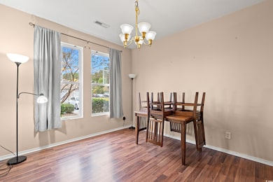 Dining space featuring wood finished floors and a chandelier