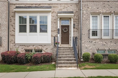 Doorway to property featuring brick siding