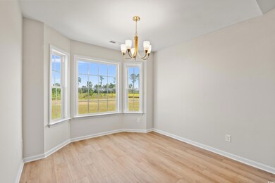 Unfurnished room featuring a chandelier and light wood-style flooring