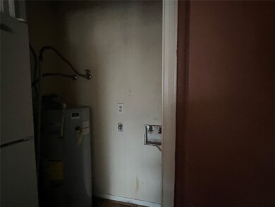 Laundry closet showing water heater too.  The bifold doors are currently off, but they are at the property to be re-installed.