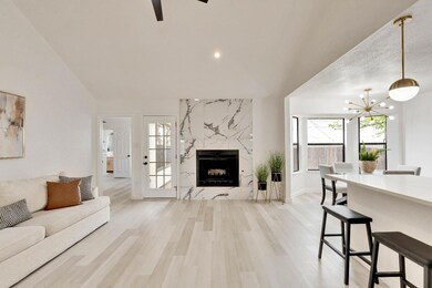 Living room with vaulted ceiling, a fireplace, li