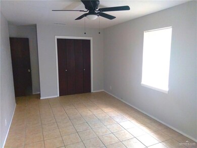 Unfurnished bedroom featuring light tile patterned floors, a closet, and ceiling fan