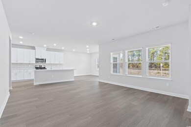 Unfurnished living room featuring light hardwood /