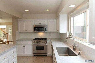 Stunning kitchen with marble counter tops and stai