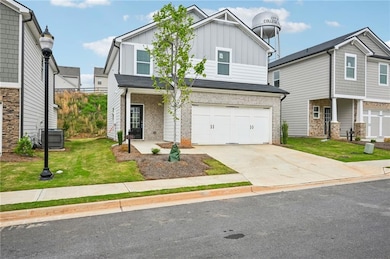 View of front of house featuring driveway, board a