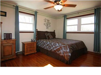 Master bedroom has beautiful hardwood floor.