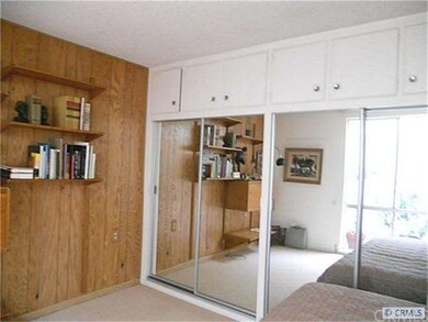 Second bedroom with mirrored closets.