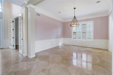 Dining room with crown molding and wainscoting.