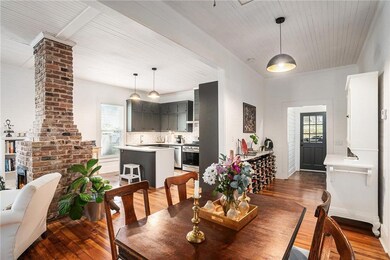 Dining space featuring light wood-type flooring, decorative columns, and wood ceiling