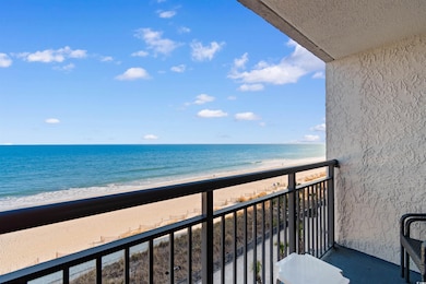 Balcony with a water view and a beach view