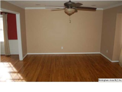 Formal living room with hardwood floors.