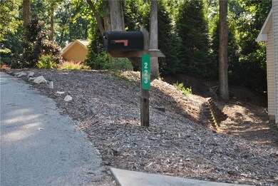 Adjacent to house at 223 Pineneedle Dr.