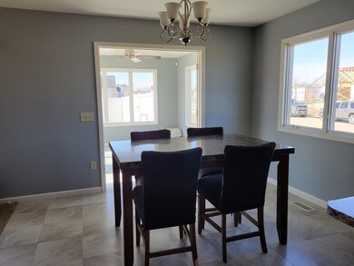 This spacious eating area flanks a large picture w