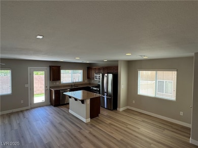 Kitchen featuring stainless steel appliances, a si