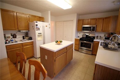The kitchen also features a ceramic tile floor.