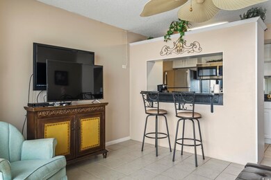 Tiled living room featuring ornamental molding, a 