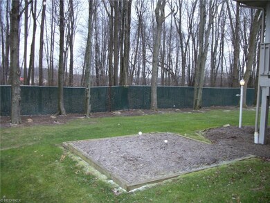 Boundary fenced area and view of wooded area.