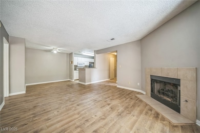 Unfurnished living room featuring a tile fireplace