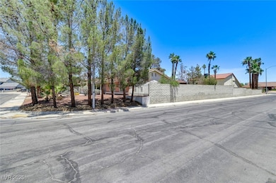 View of asphalt road featuring sidewalks, street l