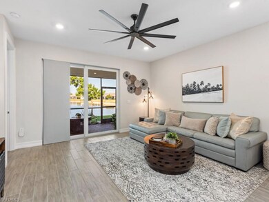 Living area with recessed lighting, light wood-sty