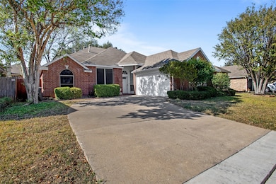 Ranch-style house with brick siding, a shingled roof, driveway, and a garage