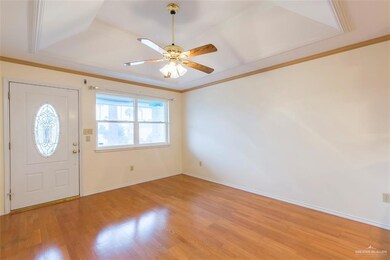 Living area with great views of front.  Well maintained and clean from top to bottom.  Custom moulding along all ceilings.  High ceilings and fans throughout.  Notice the wood moulding on ceiling casing and top and bottom trim work.