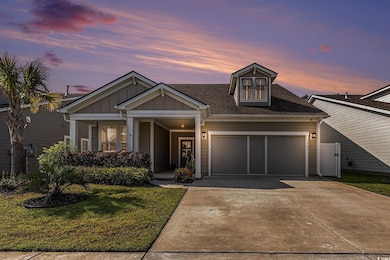 View of front facade featuring a garage, concrete driveway, a front yard, board and batten siding, and a shingled roof