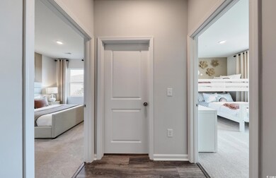 Hallway with baseboards, dark wood-style floors, a