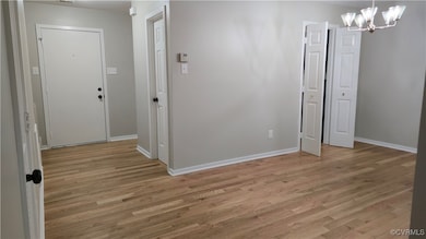 Foyer entrance with light wood-style flooring, a c