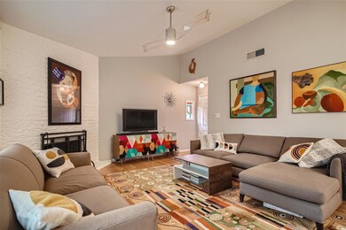 Living area with wood finished floors and lofted 