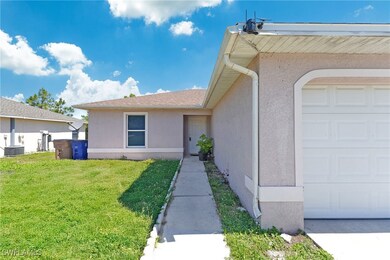 View of exterior entry featuring stucco siding, a