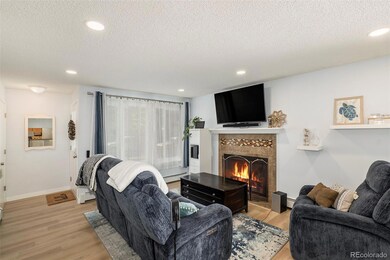 Living room with inviting fireplace and new flooring.